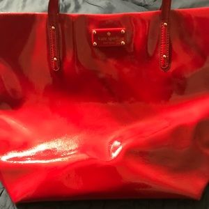 Glossy red Kate Spade tote.